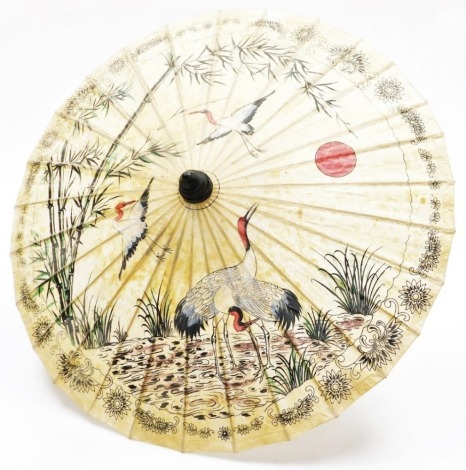 A mid 20thC Japanese parasol, with bamboo style stem and turned handle, with ebonised top and florally decorated centre, 58cm high.