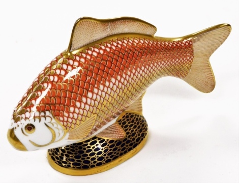 A Royal Crown Derby carp paperweight ornament, in Imari colours, silver stopper, 13cm high.