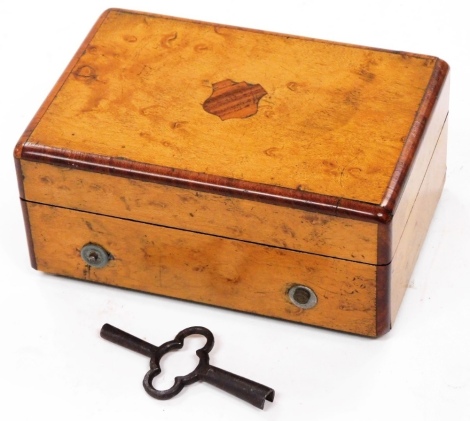 An Edwardian miniature cylinder music box, playing on two airs, with little beauty, set with brass cylinder and metal comb, in plain case with shield cartouche, 11cm wide.