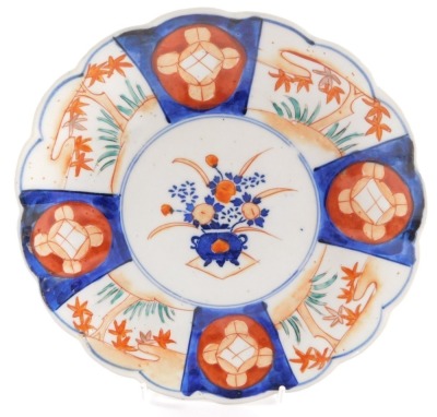 Four Japanese Imari dishes, of fluted form, decorated with reserves of flowers, Meiji period, 21/22cm diameter. (AF) - 2