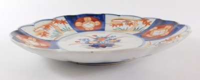 Four Japanese Imari dishes, of fluted form, decorated with reserves of flowers, Meiji period, 21/22cm diameter. (AF) - 3