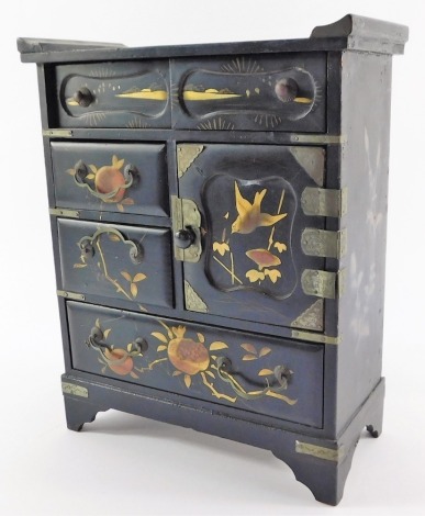 A Japanese Meiji period lacquer table cabinet, with an arrangement of drawers, and a door enclosing recesses, decorated with birds and fruit, raised on bracket feet, 26cm high, 21.5cm wide, 10cm deep.