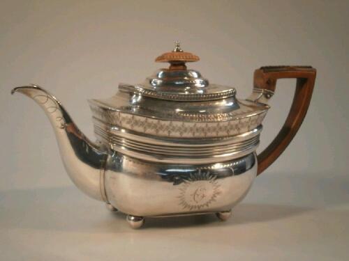 A George III silver teapot of slightly swollen rectangular design with