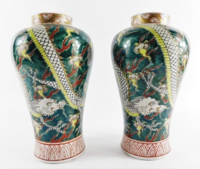 A pair of Chinese porcelain vases, of Meiping form, decorated with dragons chasing flaming pearls, above diaper borders, 25cm high. - 4