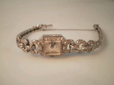 An early 20thC diamond set cocktail watch in white metal