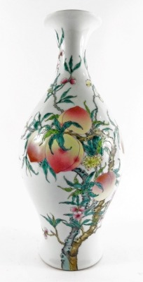 A Chinese porcelain famille rose vase, of baluster form, decorated with peaches and blossom, bears six character Yongzheng mark, 35cm high.