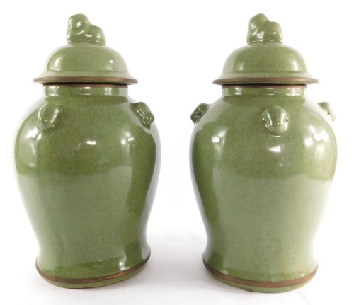 A pair of Chinese celadon jars and covers, of baluster form, with a crackle glaze, 38cm high.