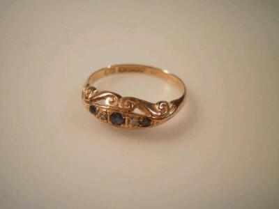 An 18ct gold dress ring set with tiny sapphires and diamond chips