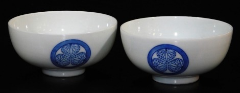 A pair of Japanese porcelain bowls, decorated with Aio (Tokugawa) mon, the base marked Tora (tiger), 10cm diameter.