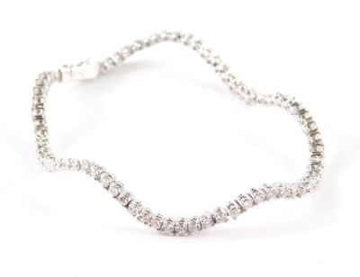 A Wempe diamond bracelet, of wave design set with seventy six diamonds, each in four claw setting with a box and tong clasp with safety clip, average diamond diameter 2.2mm, total estimated carat weight 2.9ct overall, colour G/H, clarity VVS, white metal,