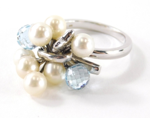 An 18ct white gold pearl diamond and blue topaz set dress ring, with cluster design of two pale blue topaz, and six pearls with a single star drop, ring size O½, 9.1g all in.