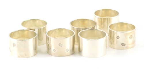 A set of seven Elizabeth II silver napkin rings, by Dawson of Stamford, of plain circular form, Sheffield 2005, 17.8oz. With the option of the next lot at the same price.