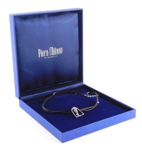 A Piero Milano 18ct white gold horse pendant and chain, the arched pendant with swivel galloping horse, numbered 325051, on a two row leather necklace, the pendant 4cm high, the chain 32cm long, boxed.