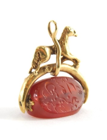 A silver agate fob, with a figure of a horse on wishbone, with three sided orange agate swivel fob, with pendant loop, yellow metal, unmarked, 2cm high, 3.7g all in.