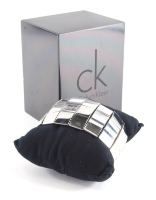 A Calvin Klein stainless steel ladies wristwatch, model K40211, with silvered finish, three row box links, 20cm long, boxed.