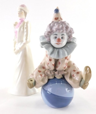 A 20thC Lladro Daisa figure of a clown, seated on ball, printed marks beneath,18cm high, and a Coalport Ladies of Fashion figure Janet. (2, 1 AF)