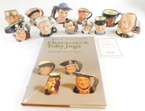 A collection of Royal Doulton small character jugs, to include the Airman, Merlin, Mark Twain, Thomas Sawyer, etc., and Eyles (Desmond) character and Toby jugs book.