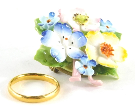 A plain wedding band, yellow metal, marks pitted, size K, 2.5g, and a floral brooch in Harrods box. (2)