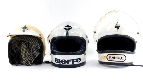 Three motorcycle helmets, comprising a Kangol white helmet, a BFE Bieffe helmets white crash helmet and a stadium S helmet with visor. (3)