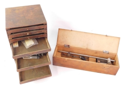 A group of steam loco parts, totem wheels, screws, tap dies, cased clamp, etc. (2 wooden boxes)