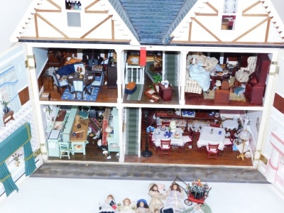 An doll's house with extensive contents, over three various floors with dining suite, bedrooms, and accessories, 102cm high, 110cm wide, 42cm deep. - 2