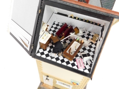 An doll's house with extensive contents, over three various floors with dining suite, bedrooms, and accessories, 102cm high, 110cm wide, 42cm deep. - 5