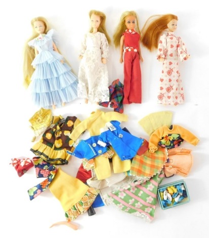 Four Pippa dolls, to include one in blue ruffled dress numbered 43 2, white dress numbered 3371, a white love heart dress numbered 3, and one in a red play suit, together with various clothing and shoes.