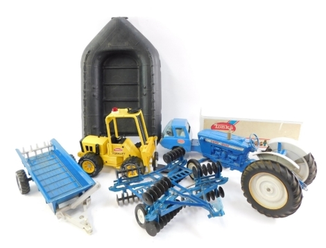 Ertl and Tonka die cast farm vehicles and machinery, comprising a Ford 4000 tractor, bail loader and plough, a Tonka forklift, Action Man dingy and a Tonka lorry and trailer. (1 box)