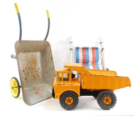 A Mighty Tonka hydraulic dumper truck, child's pushchair and a child's wheelbarrow. (3)