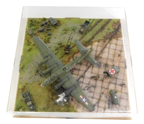 A diorama of a Boeing B17 Flying Fortress, 1:72 scale, crash landed with figures, in perspex case.