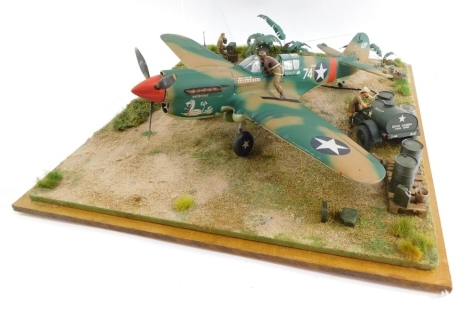 A diorama of a Curtiss P40 Warhawk, 1:32 scale, with figures, in a perspex case.