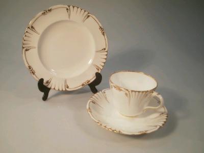 A 19thC white ground pottery part tea service with gilt decoration