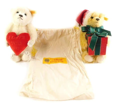 A Steiff I Love You XX Teddy bear holding a heart, together with a Steiff Christmas Teddy bear holding a Christmas box. (2)