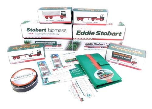 A group of Eddie Stobart models, flat bed truck, Stobart manual, certificates of authenticity, Scania Top Line Curtain Side, AEC six wheel tipper, Volvo FH fridge trailer, collector's tin, box lorry, flat bed truck, R440 High Line Anchor and R440 High Lin