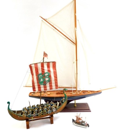 Various model boats, comprising a pond yacht painted blue with white mast, a replica Viking boat and a small fishing boat. (3)