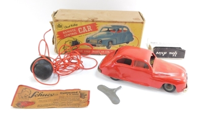 A Chad Valley clock work remote control car, boxed.