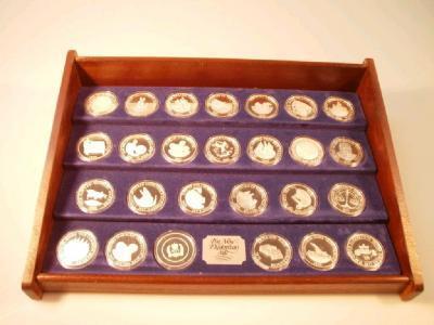 A display case containing twenty six silver commemorative coins