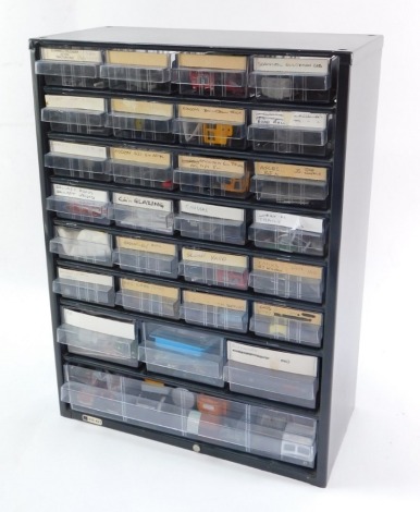 A set of metal filing drawers, with various kit building accessories, to include radiators, chassis, AEC cabs, tank parts, wheels, etc. (a quantity)