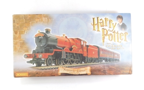 A Hornby R1033 Harry Potter and The Chamber of Secrets Hogwarts Express train set, including Hogwarts castle locomotive, two coaches, track, transformer, etc, boxed (AF)