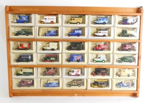 A group of models of Yesteryear vans, in a pine display case, thirty cars, all boxed.