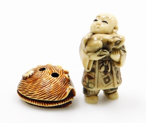 Two netsuke type figures, depicting a conch shell and a man holding a fish. (2)