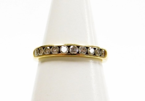 An 18ct gold and diamond half hoop eternity ring, set with ten round brilliant cut diamonds, approx 0.50ct overall, in rub over setting, ring size M, 3.5g all in, sold with ring box and outer box.