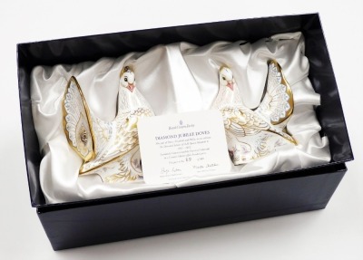 A pair of Royal Crown Derby Golden Jubilee Doves porcelain paperweights, commissioned by Goviers of Sidmouth, limited edition number 89/500, with gold stopper and gold printed marks to underside, 16cm high, boxed, with certificate.