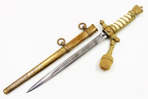 A German Third Reich Kriegsmarine officers dagger, with scabbard and engraved blade, stamped Paul Weyersberg & Co, 42cm long overall.