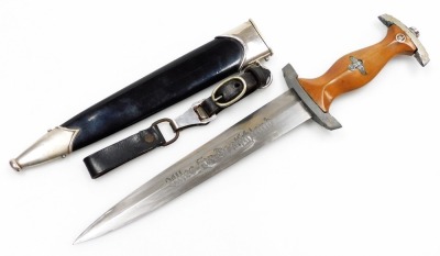 A German Third Reich SA dagger, with polished steel and ebonised scabbard, wooden handle and engraved blade, 37cm long.