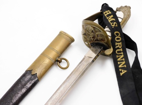 A Naval dress sword, with simulated shagreen handle bound with brass wire, the guard stamped with an anchor, the leather scabbard mounted with engraved brass scabbard, 97cm long. (AF)