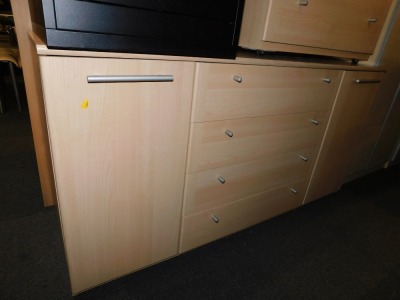 A birch effect sideboard, with four drawers flanked by cupboards.