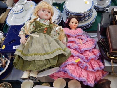 Two dolls, to include a ceramic collectors doll and a plastic doll with wool flared dress.