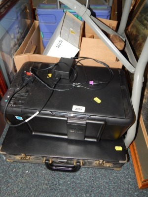 A HP printer, push along trolley, and briefcase.