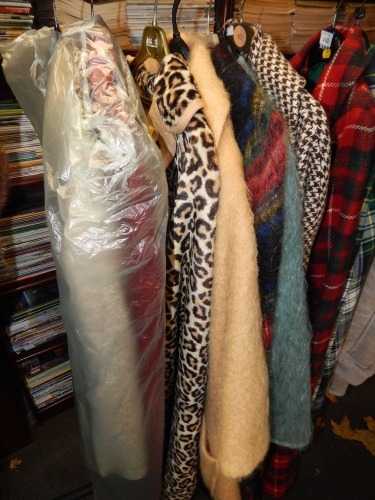 A group of vintage clothing, shaggy fur jackets, over coats, etc.